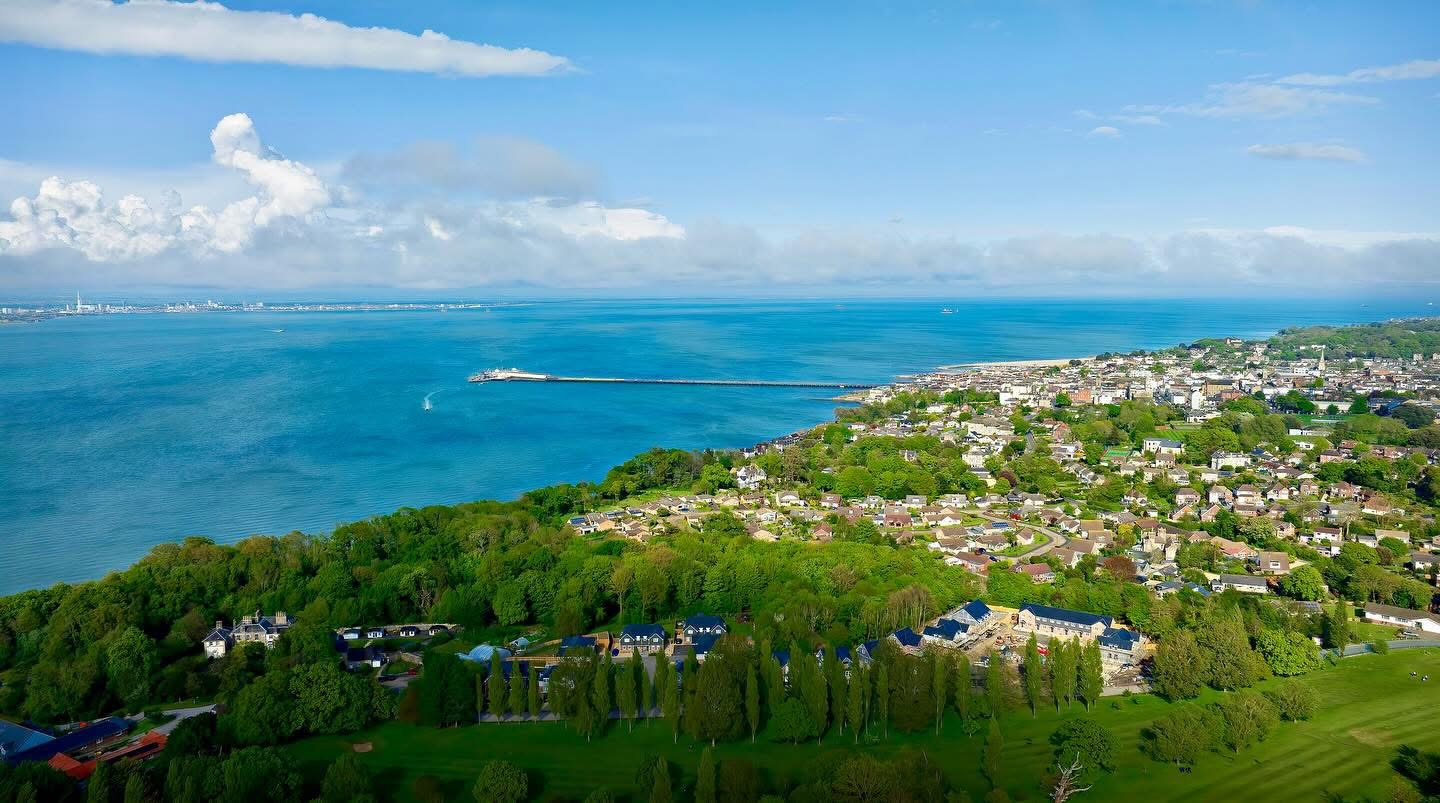 Coastal town, pier and links from the air, Isle of Wight — destination photography by Samuel John Ford