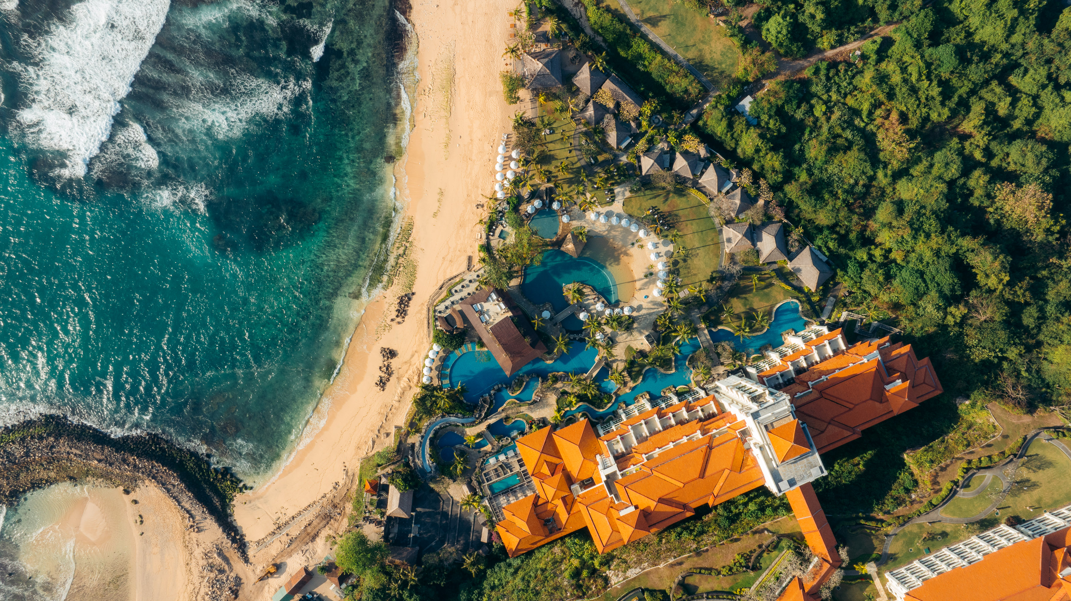 Beachfront resort pools from the air — hotel photography by Samuel John Ford