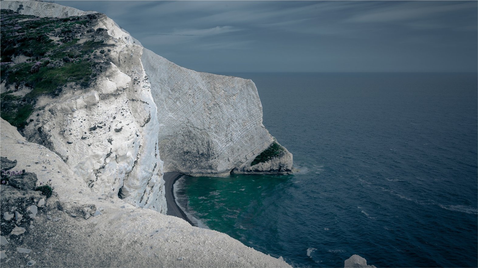 Dramatic chalk cliff and hidden cove with emerald sea, Isle of Wight coastline — landscape photography by Samuel John Ford